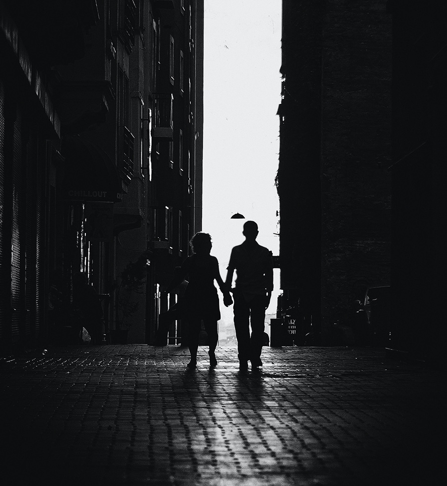 photo-of-man-and-woman-walking-in-alley-2020312